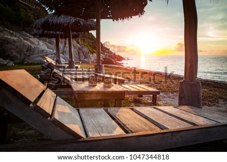 beautiful sunset sky and wood desk on sea beach 