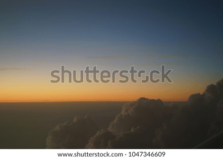 Sunset above clouds from airplane window