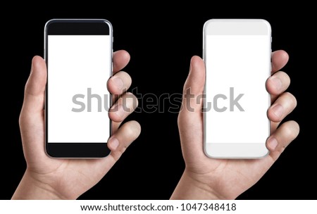 Hands holding white and black smartphones with blank screens, isolated on black background