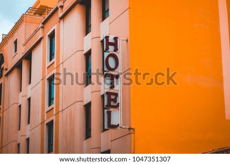 typical hotel sign in red letters on white ground