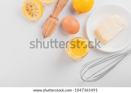 lemon curd in a glass jar on a white background, ingredients for cooking, lemon kyrd recipe
