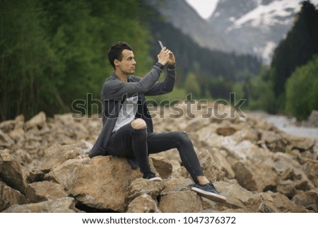 young man taking a photo with his mobile phone