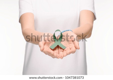 cropped shot of woman holding green ribbon in hands isolated on white, world health day concept