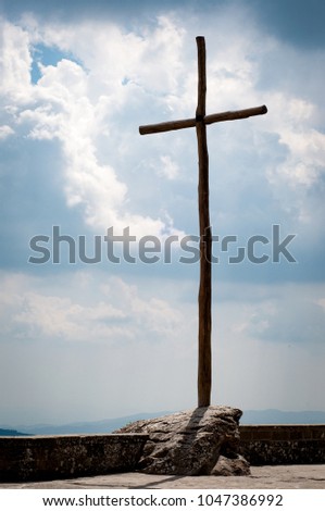 cross on cloudy sky background. wooden cross.