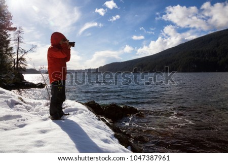 Photographer taking pictures of the beautiful landscape from Twin Island in Indian Arm, North of Vancouver, British Columbia, Canada.