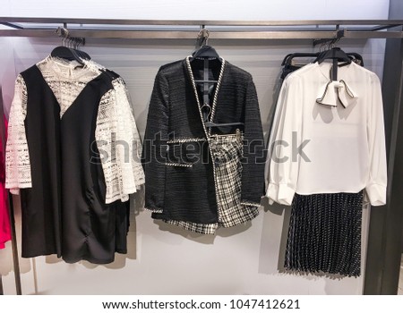  sweater, sundress ,shirts clothes on hangers in the store