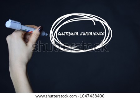 The businessman writes an inscription with a white marker:CUSTOMER EXPERIENCE