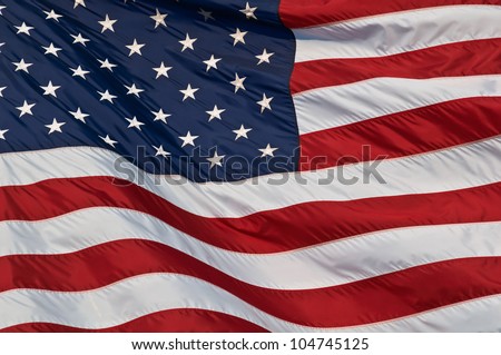 United States of America flag. Image of the american flag flying in the wind. Royalty-Free Stock Photo #104745125