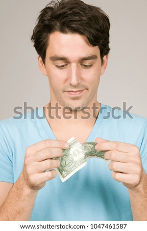 Man ripping a dollar