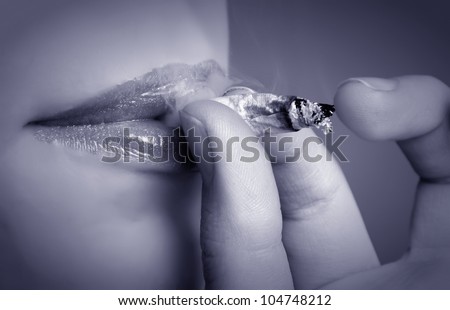 female mouth smoking cigarette.toned picture