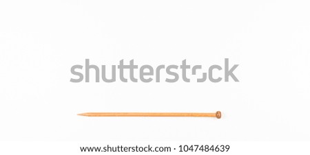 Wooden knitting needle on white background.