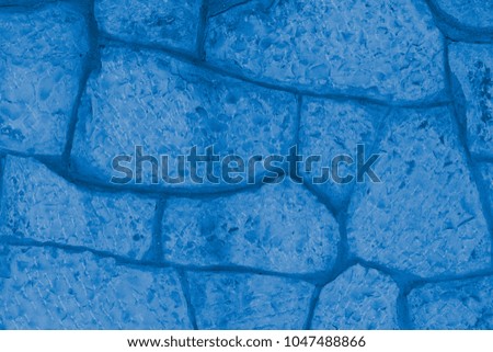 Horizontal stone wall of a nature rock - close up. Toning in pantone color marina.