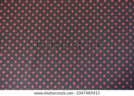 Fabric with polka dot pattern in black and red from above