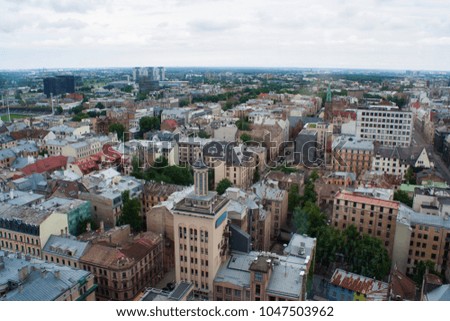 Old buildings of Riga. View from a height. Many roofs and modern buildings are behind.