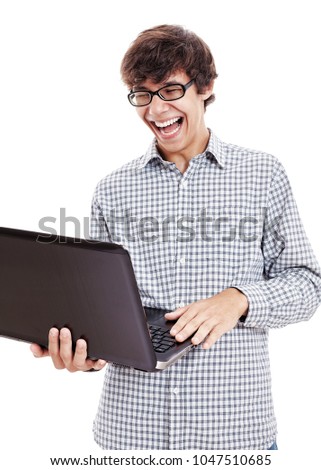 Young hispanic man wearing blue checkered shirt and black glasses reading something funny from his laptop and loudly laughing isolated on white background - internet humor and fun