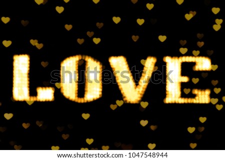 blurred text yellow gold LOVE sign LED Bokeh neon light yellow gold on background bokeh lights heart soft colorful
