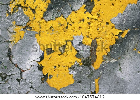 Strong surface structure with rest of yellow paint on concrete wall for abstract backgrounds. Germany
