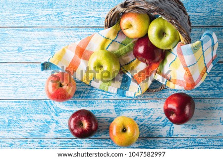 apples in a basket on a blue background