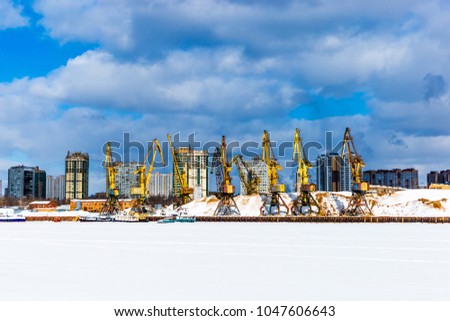 Port cranes in river port at winter day in Moscow, Russia.