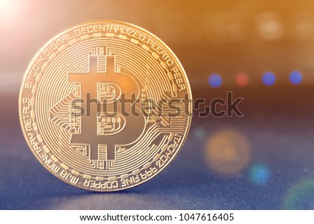 Bitcoin and  Physical bit coin. Digital currency. Cryptocurrency. Golden coin with bitcoin symbol.
