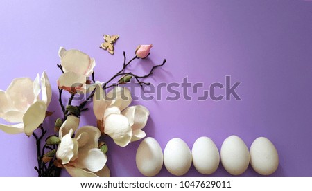 Easter background with eggs and magnolia flower.