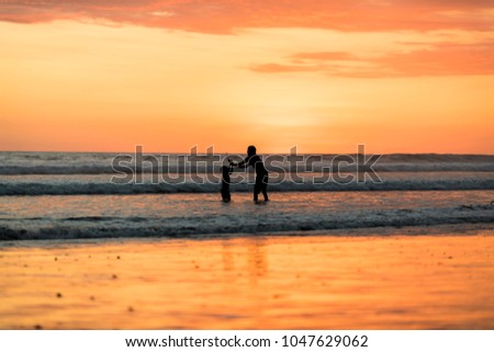 Father with is son at the sunset