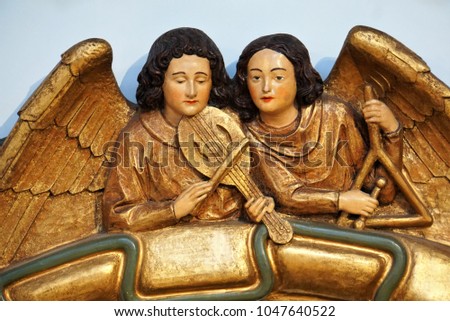 Angels with Musical Instruments in the Light. Decorative Elements of Catholic Church of Historical City in Germany.