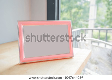blank photo frame with copy space on table at room