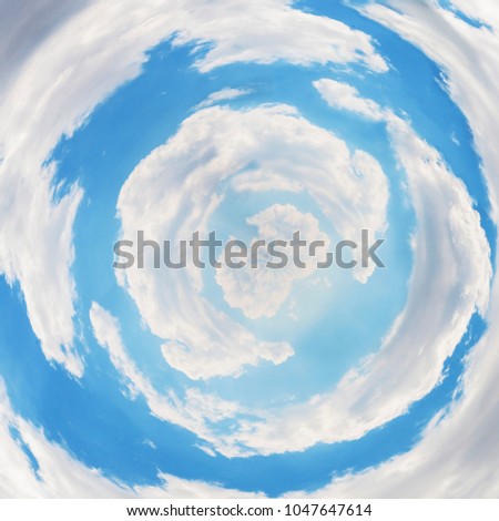  Tiny planet of blue sky in sunny day. Small earth sphere photo through a tunnel of clouds, as if it were the entrance to paradise Royalty-Free Stock Photo #1047647614