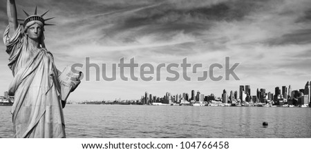 photo black and white new york panorama panoramic city skyline. new york  statue of liberty over looking new york manhattan midtown skyline. beautiful black and white from nyc over hudson river.