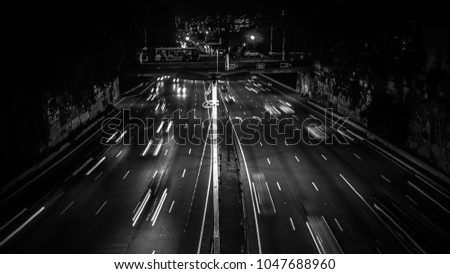 Cars on the avenue at night on "Avenida Radial Leste" in Sao Paulo Capital Brazil. Slow shutter speed to record car light trails. Image in White and Black.