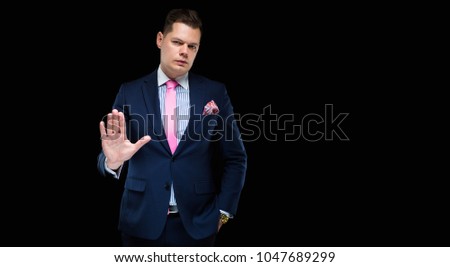 Portrait of confident handsome businessman stretch his hand forward on black background