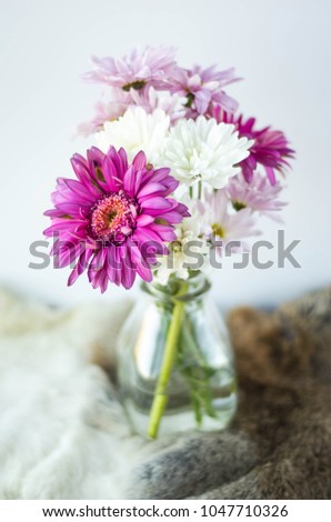 Bouquet of Flowers pink and white with feathers on brown fur pelt