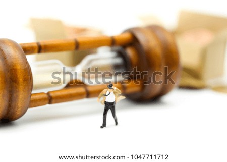 Miniature people :  businessman and Tie blowing in wind stand with Sandglass, hourglass.