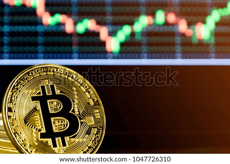 Golden Bit coins place on stock graph background.