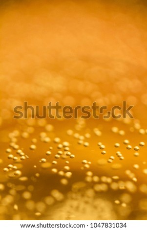 Golden bubbles inside a champagne glass