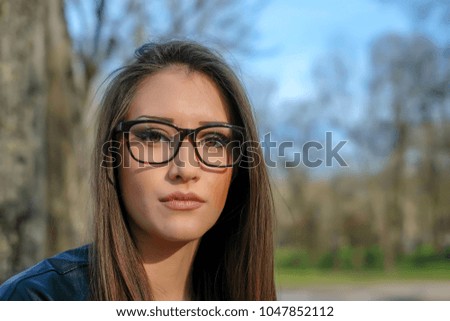 beautiful girl wears glasses with black hair and long with nails