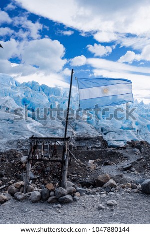 Argentina flag flying in front of Perito Moreno Glacier