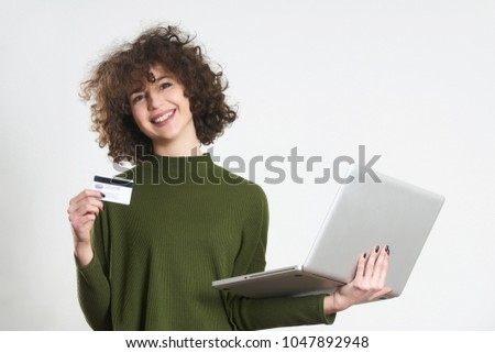 Pretty girl holding credit card and laptop, concept