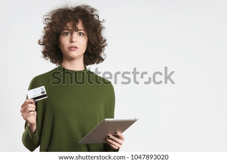 Pretty hipster girl using tablet and credit card, concept