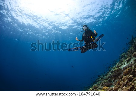 A scuba diver in deep blue of indian ocean. Picture take in Ari atoll - Maldives.