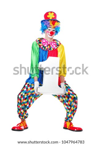 Full length picture of a standing clown in a hat and rainbow wig holding foam number one figure prop