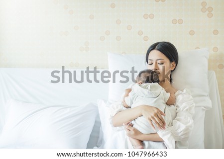 Close up portrait of beautiful young asian Indian or caucasian mother day with newborn baby, copy space with bed in the hospital. Healthcare and medical love lifestyle mother's day concept