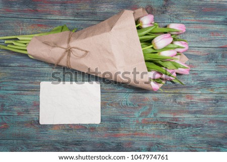 Pink tulips flowers on wooden background selective focus place for text