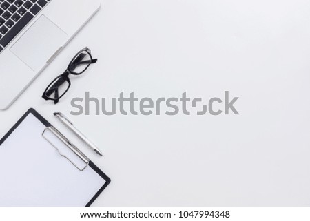 White office desk table laptop with notebook  on white table background. Top view. Flat lay style.