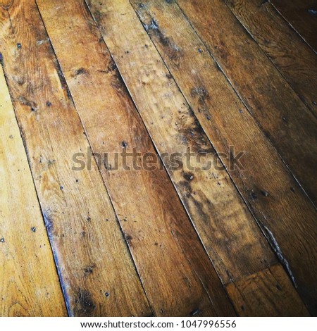 Full frame close up texture of old wooden floorboards. Mobile phone photo with some Instagram style processing.