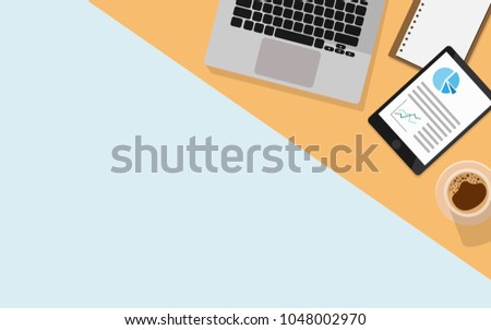 Top aerial View of business desk table with laptop,empty business paper work,a cup of coffee, notebook,tablet and copy space for text