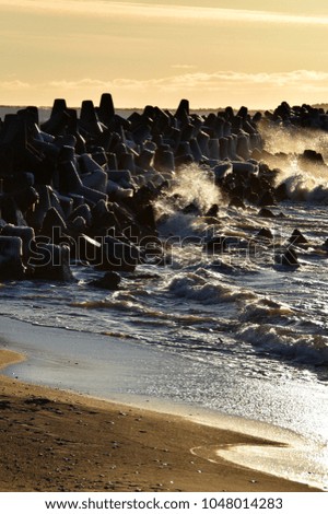 Baltic sea waves crashing against the port mole at spring in Liepaja, Latvia.