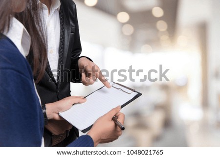 Image of two young business using at meeting