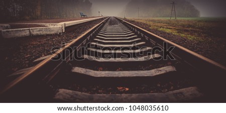 rails of the railway station at the station. Autumn season, in the countryside. Panoramic and web banner format.